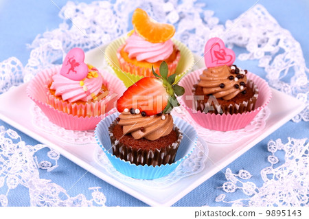 Assorted cup cakes with angel, heart, tangerine, strawberry Assorted cup cakes with angel, heart, tangerine, strawberry 9895143