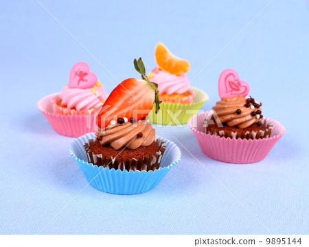 Four appetizing cupcakes with angel, heart, tangerine, strawberry Four appetizing cupcakes with angel, heart, tangerine, strawberry 9895144
