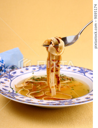 Pancake soup in blue plate, eating 9895174