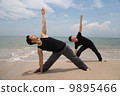Two asian male doing yoga on the beach 9895466