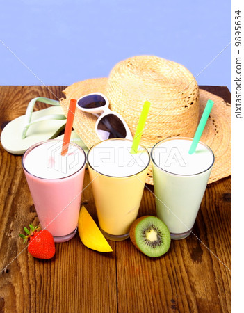 Strawberry, mango and kiwi soft drink with holiday background Strawberry, mango and kiwi soft drink with holiday background 9895634