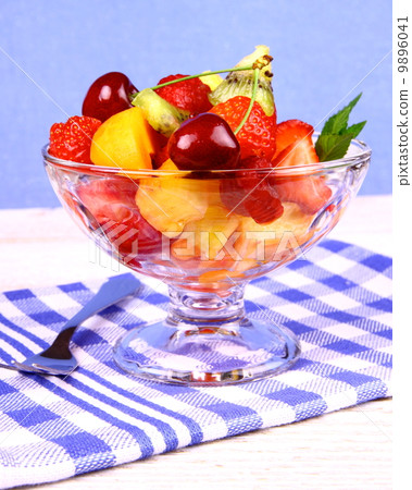 Fruits salad in glass bowl and dessert fork 9896041