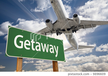 Getaway Green Road Sign and Airplane Above Getaway Green Road Sign and Airplane Above 9896609