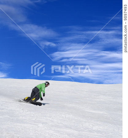 Snowboarder on ski slope 9897493