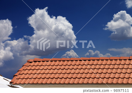 Roof tiles, snowy slope and blue sky with clouds Roof tiles, snowy slope and blue sky with clouds 9897511