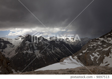Snowy mountains and storm clouds Snowy mountains and storm clouds 9897513