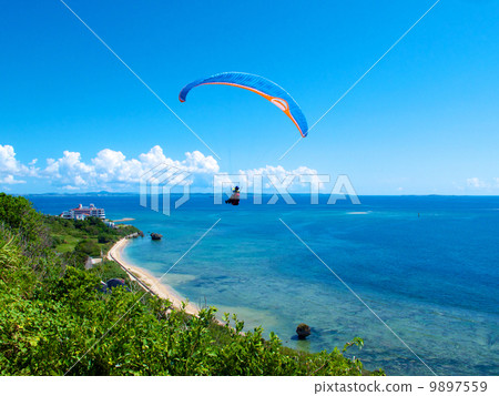Blue sea and paragliding Blue sea and paragliding 9897559