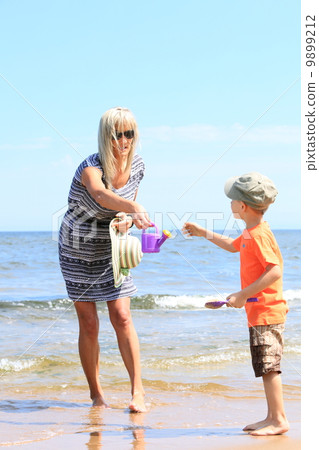 happy mother and son playing on beach happy mother and son playing on beach 9899212