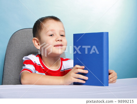 child boy kid reading a book on blue 9899215