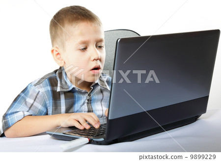 Computer addiction child with laptop notebook Computer addiction child with laptop notebook 9899229