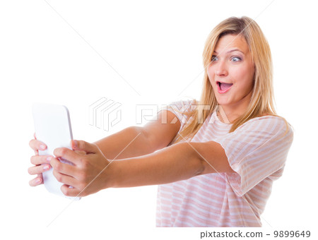 Surprised emotional girl using tablet touchpad e-book e-reader Surprised emotional girl using tablet touchpad e-book e-reader 9899649