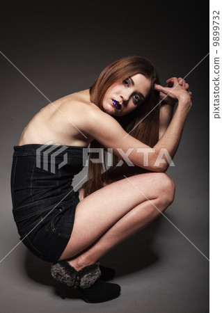Sad unhappy girl young woman with long hair and creative makeup 9899732