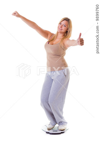 Woman plus size on scale celebrating weightloss thumb up isolated Woman plus size on scale celebrating weightloss thumb up isolated 9899760