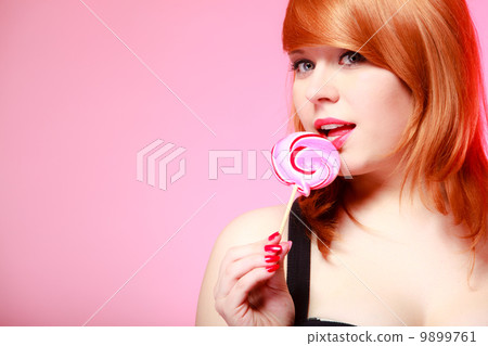 Sexy young woman holding candy. Redhair girl eating sweet lollipop Sexy young woman holding candy. Redhair girl eating sweet lollipop 9899761