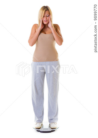 Large woman on scale worried with her weight isolated 9899770