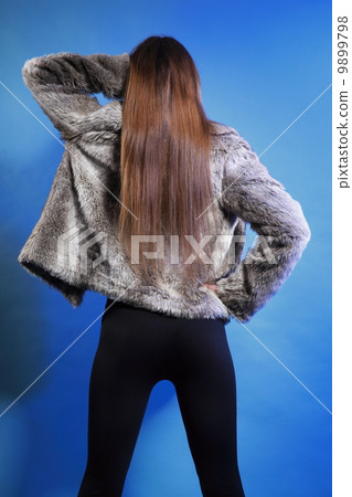 young woman in fur long hair blue background young woman in fur long hair blue background 9899798