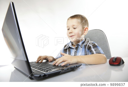 Computer addiction child with laptop notebook Computer addiction child with laptop notebook 9899837