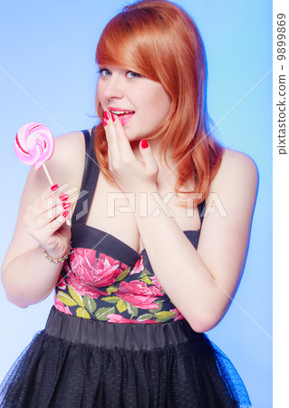 Sexy young woman holding candy. Redhair girl eating sweet lollipop Sexy young woman holding candy. Redhair girl eating sweet lollipop 9899869