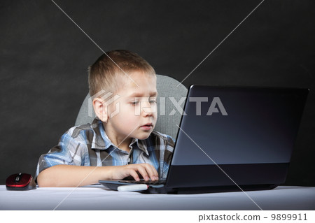 Computer addiction child with laptop notebook Computer addiction child with laptop notebook 9899911