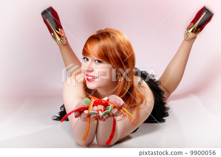 happy redhair woman with gummy candy 9900056