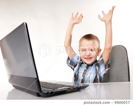 Triumphing child with a laptop computer isolated Triumphing child with a laptop computer isolated 9900057