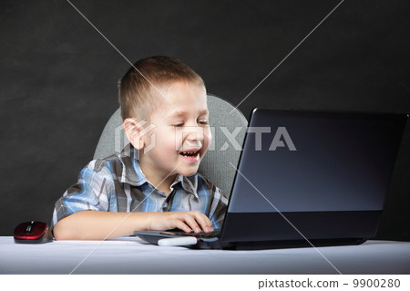 Computer addiction child with laptop notebook Computer addiction child with laptop notebook 9900280