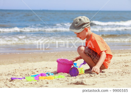 boy playing toys on beach boy playing toys on beach 9900385