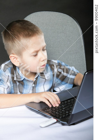 Computer addiction child with laptop notebook 9900402
