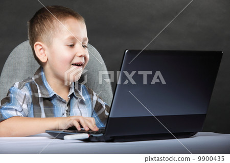 Computer addiction child with laptop notebook 9900435