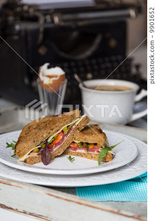breakfast from toasts, boiled egg and tea on typewriter backgrou breakfast from toasts, boiled egg and tea on typewriter backgrou 9901652
