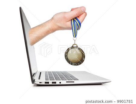 Medal winner in the man's hand sticking out of the laptop. Conce 9901781