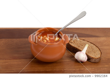 Soup in ceramic pot with bread and garlic Soup in ceramic pot with bread and garlic 9902164