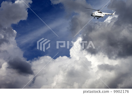 Helicopter in blue sky with clouds 9902176