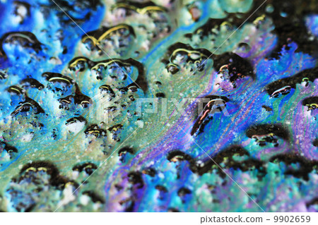 Color gasoline fuel spot on black asphalt 9902659