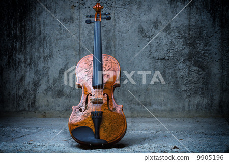 Violin on concrete wall 9905196