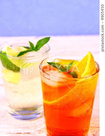 Orange, elderflower cocktails on blue background Orange, elderflower cocktails on blue background 9905450