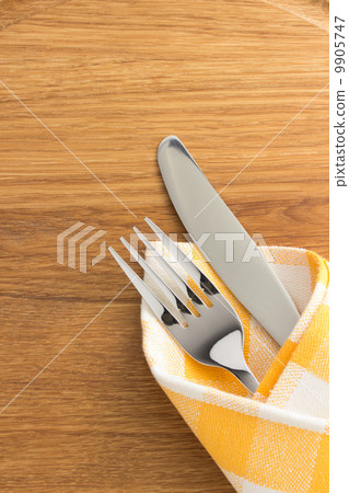 knife and fork at napkin on wood knife and fork at napkin on wood 9905747