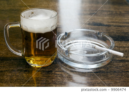 glass of beer and an ashtray 9906474