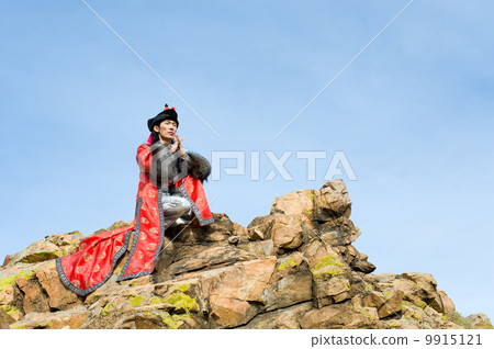 man in Mongolian costume on rock 9915121