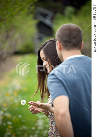 Woman Holding a Dandelion Woman Holding a Dandelion 9915797