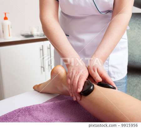 Beauty salon. Woman getting spa hot stone legs massage Beauty salon. Woman getting spa hot stone legs massage 9915956