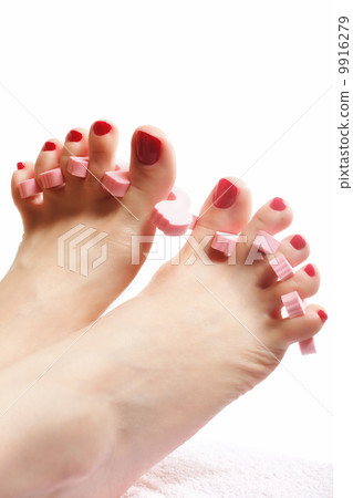 foot pedicure applying red toenails on white foot pedicure applying red toenails on white 9916279