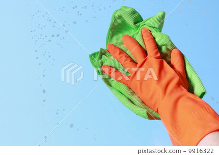 Gloved hand cleaning window with rag Gloved hand cleaning window with rag 9916322