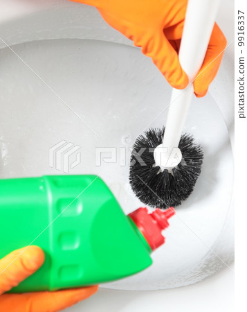 Gloved hand cleaning toilet bowl using brush Gloved hand cleaning toilet bowl using brush 9916337