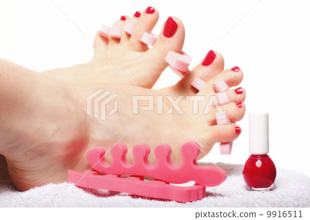 foot pedicure applying red toenails on white foot pedicure applying red toenails on white 9916511