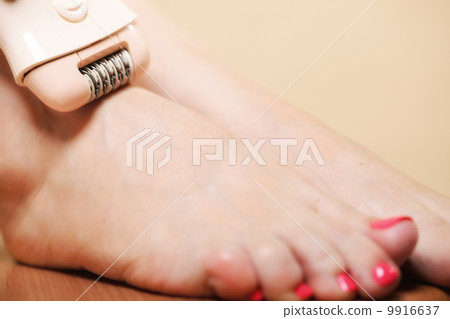 woman shaving leg with shaver depilation body care 9916637
