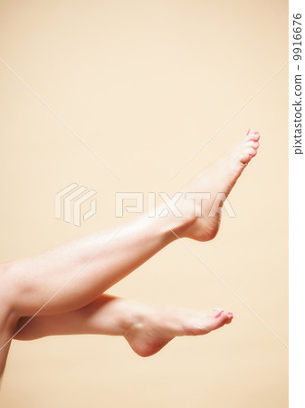Beautiful long naked woman girl legs on orange Beautiful long naked woman girl legs on orange 9916676