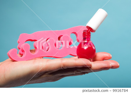 foot pedicure red nail polish and toe separators 9916784