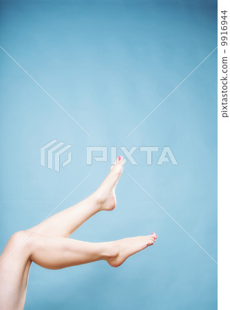 Beautiful long naked woman girl legs on blue Beautiful long naked woman girl legs on blue 9916944