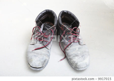 pair of old dirty work boots in building site pair of old dirty work boots in building site 9917015